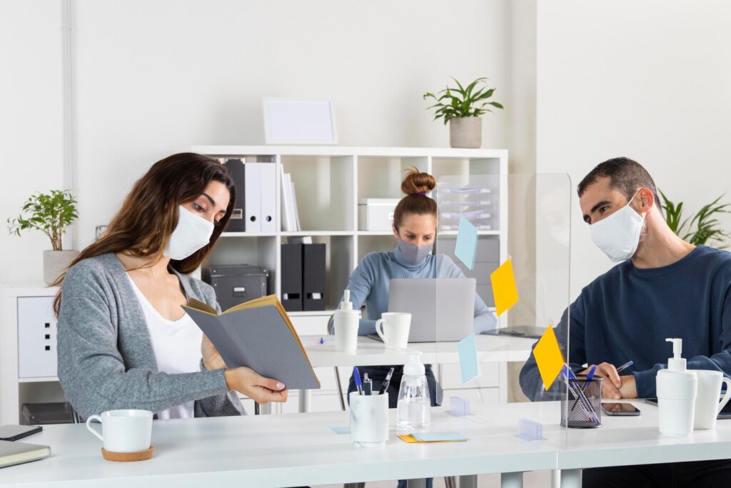 medium-shot-coworkers-wearing-masks_23-2148862104