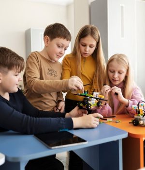 four-kids-building-drone-using-electronic-parts_23-2149357696