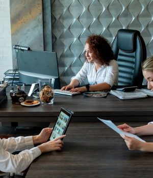 group-business-women-sitting-office-desk-with-documents-using-laptop-computer-with-serious-confident-expression-working-together-office_141793-21243