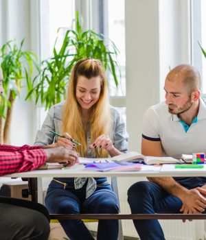 group-smiling-people-working-table_23-2147655879